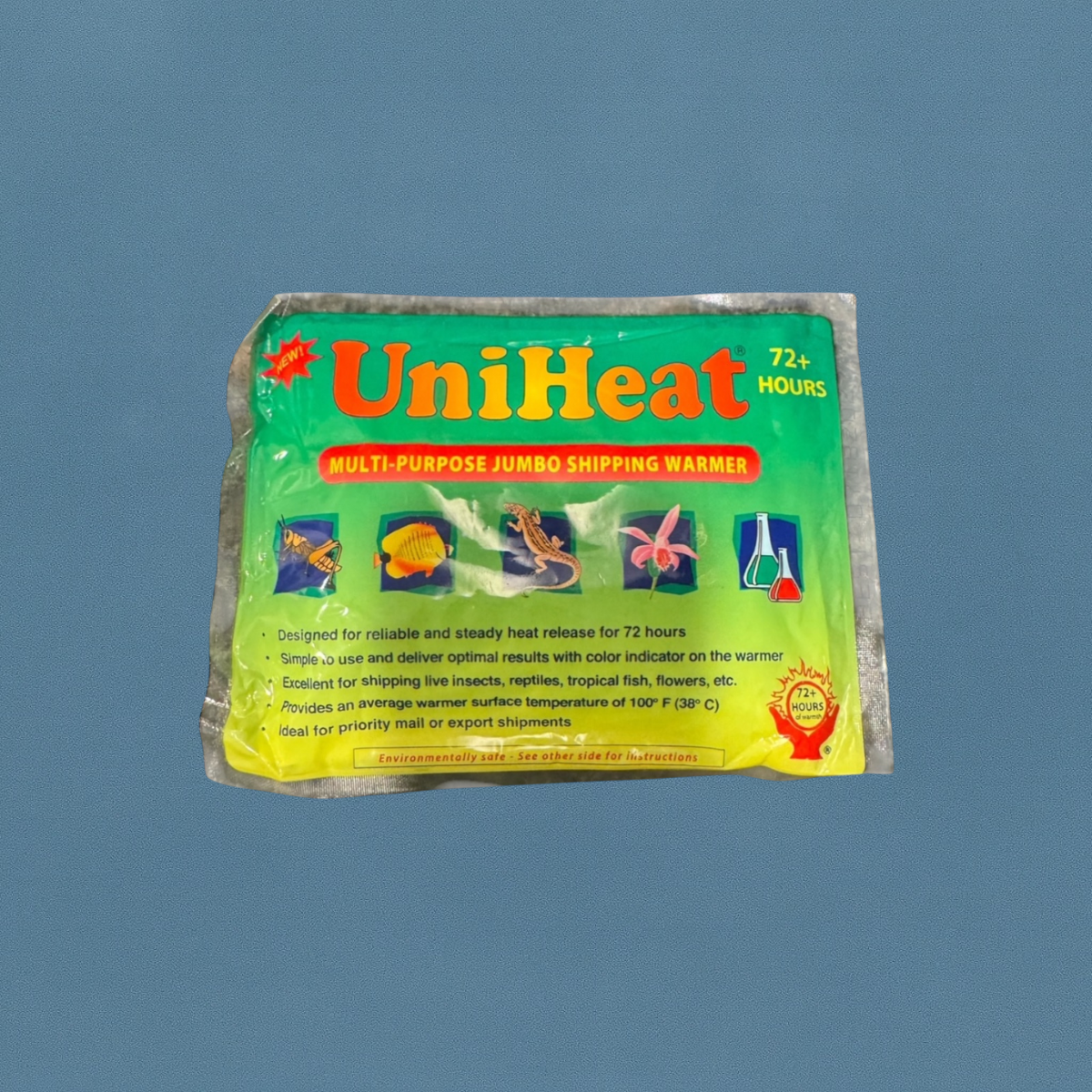 UniHeat 72+ Hour Multi-Purpose Jumbo Shipping Warmer in green and yellow packaging, showing images of tropical fish, reptiles, and plants, photographed on a blue background.