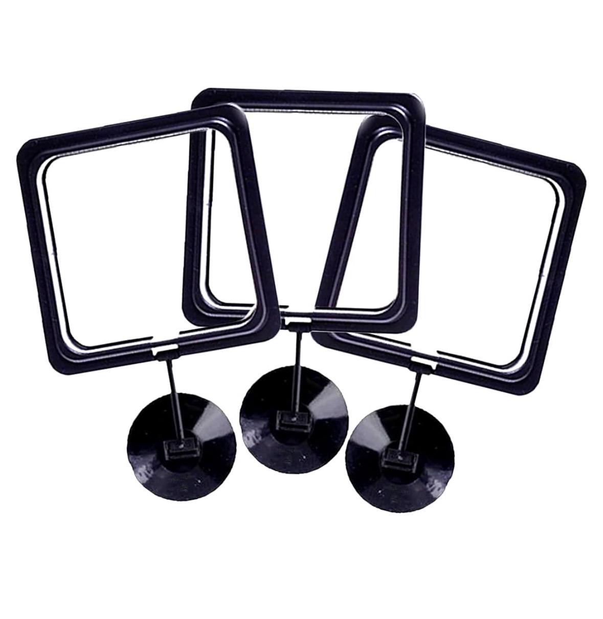 Set of three black square aquarium feeding rings with adjustable stands, displayed on a white background, used to keep floating fish food contained in aquariums.