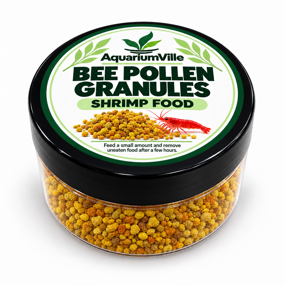 A clear plastic jar of AquariumVille Bee Pollen Granules Shrimp Food with a black lid and a white label featuring green and black text, filled with yellow-orange bee pollen.
