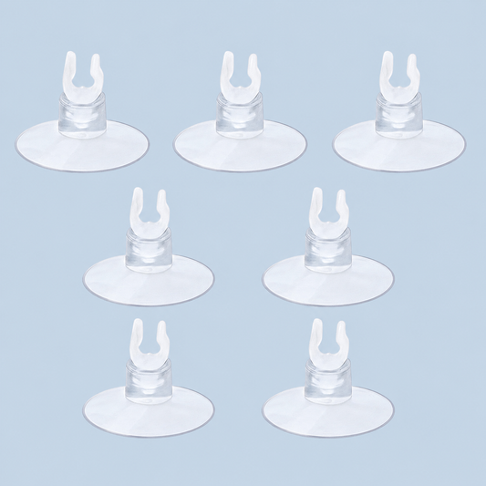Seven clear aquarium suction cup clips arranged on a light blue background, commonly used for holding airline tubing, heaters, or aquarium accessories in fish tanks.