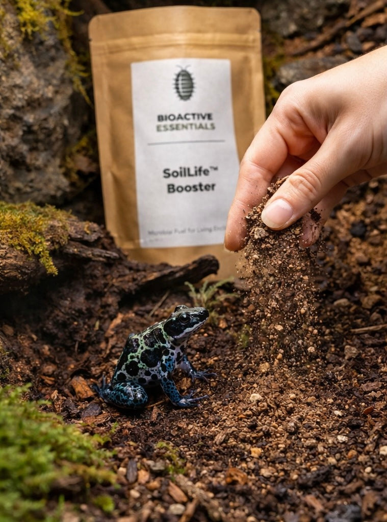 Hand adding soil life booster to soil with a small frog nearby