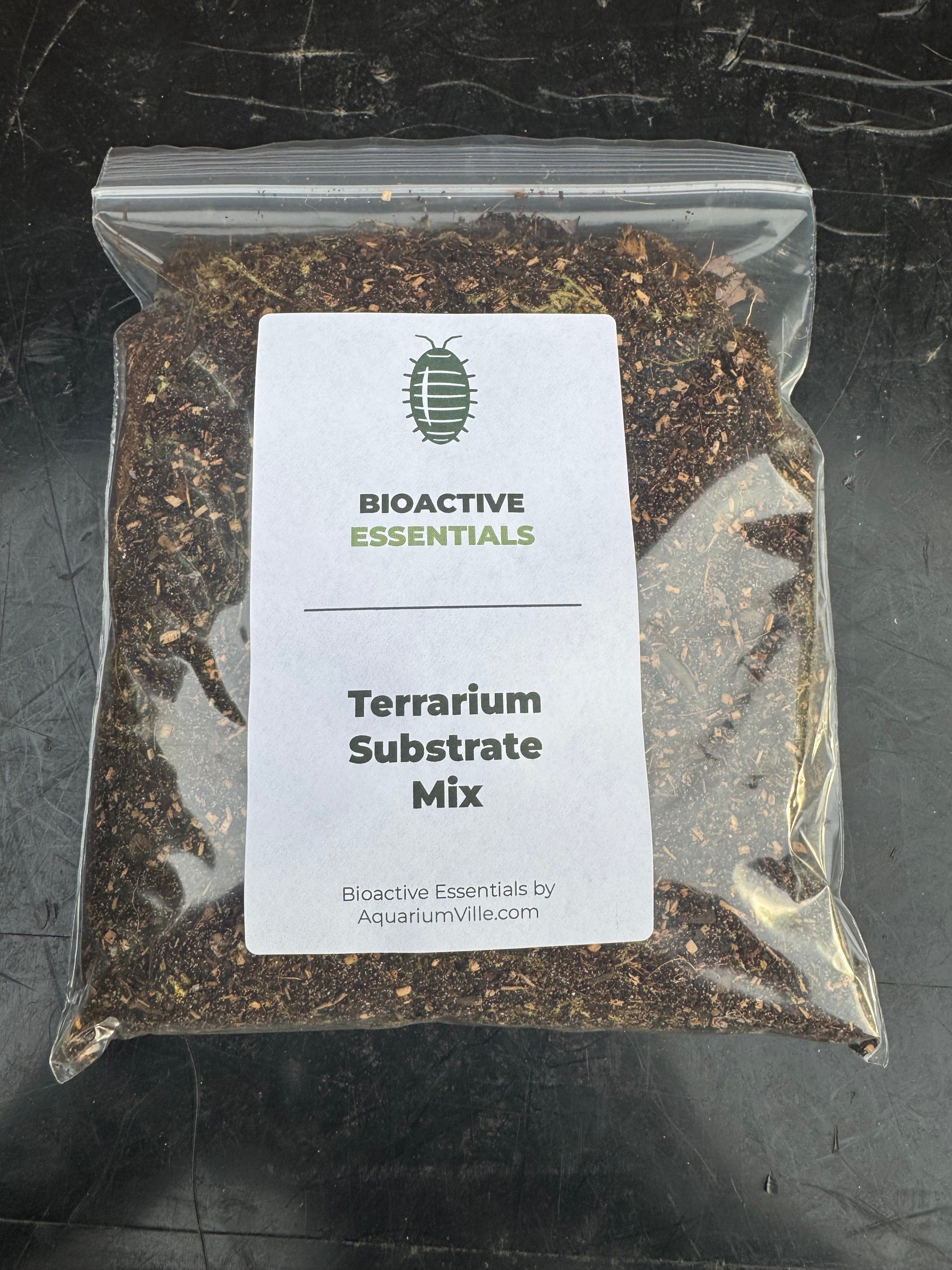Bag of Bioactive Essentials Terrarium Substrate Mix displayed on a dark background. The clear resealable bag reveals a premium blend of soil, bark, leaf matter, and moss, with a clean product label suitable for bioactive terrariums, vivariums, and isopod habitats.