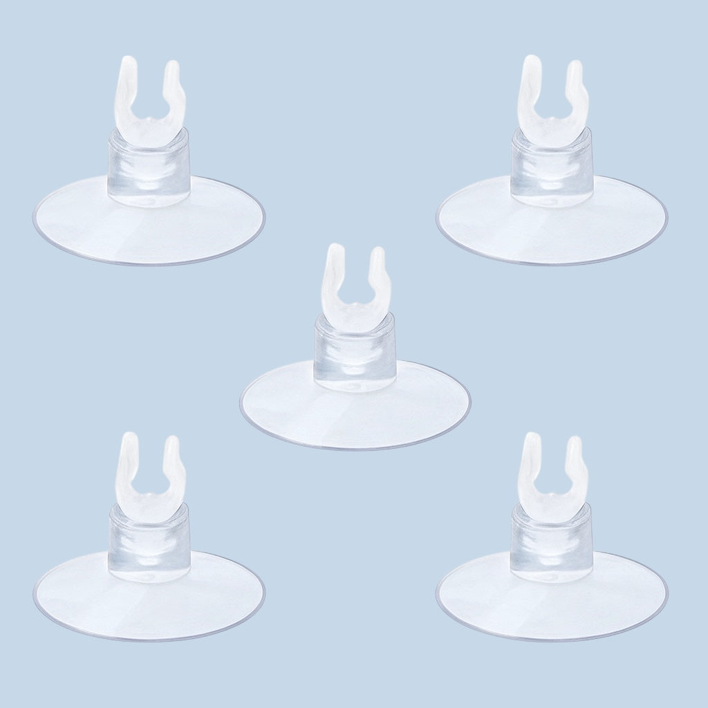 Five clear plastic aquarium suction cup clips for securing airline tubing, evenly spaced on a light blue background.