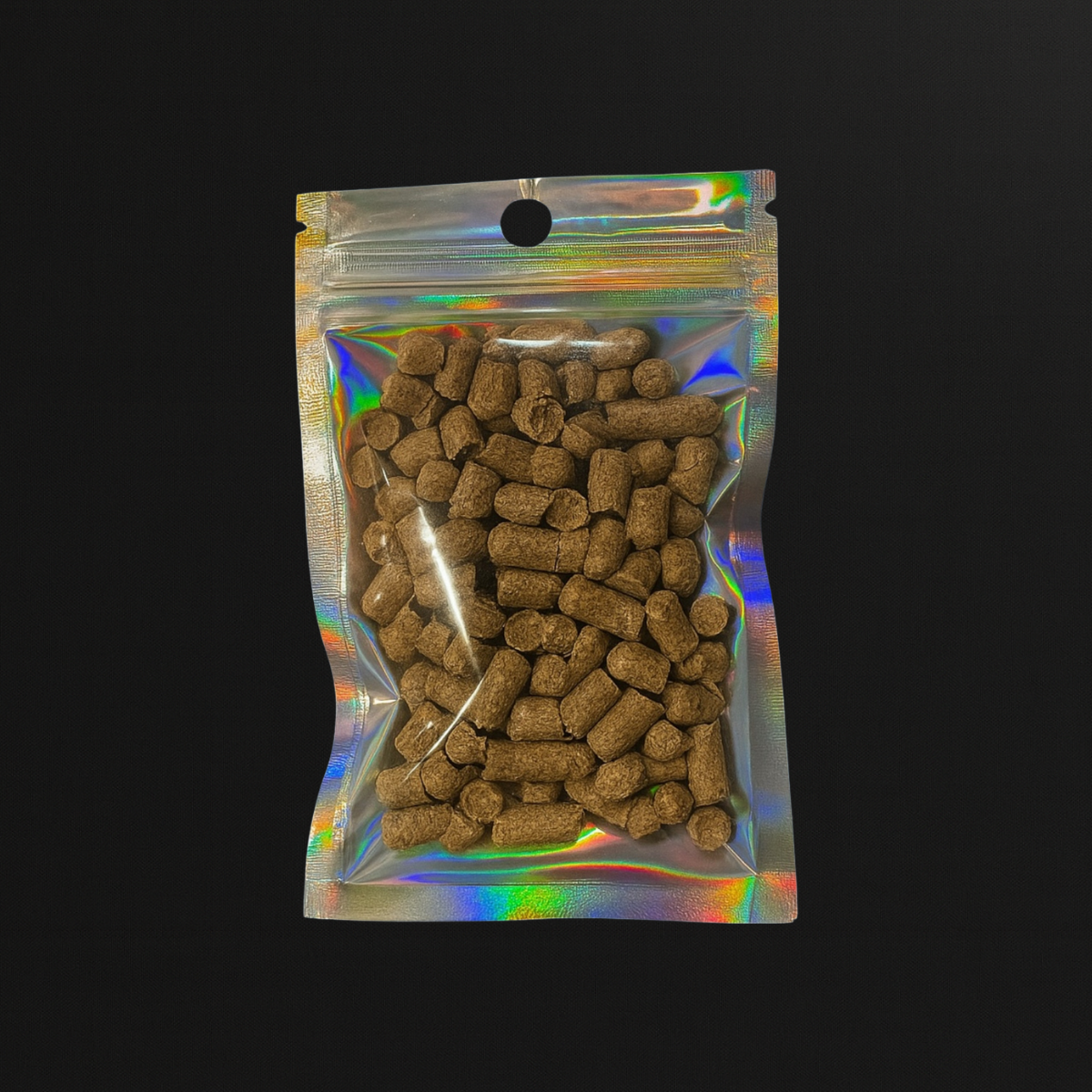 Packaged barley pellets, shrimp food and snail food, in a reflective plastic bag on a black background