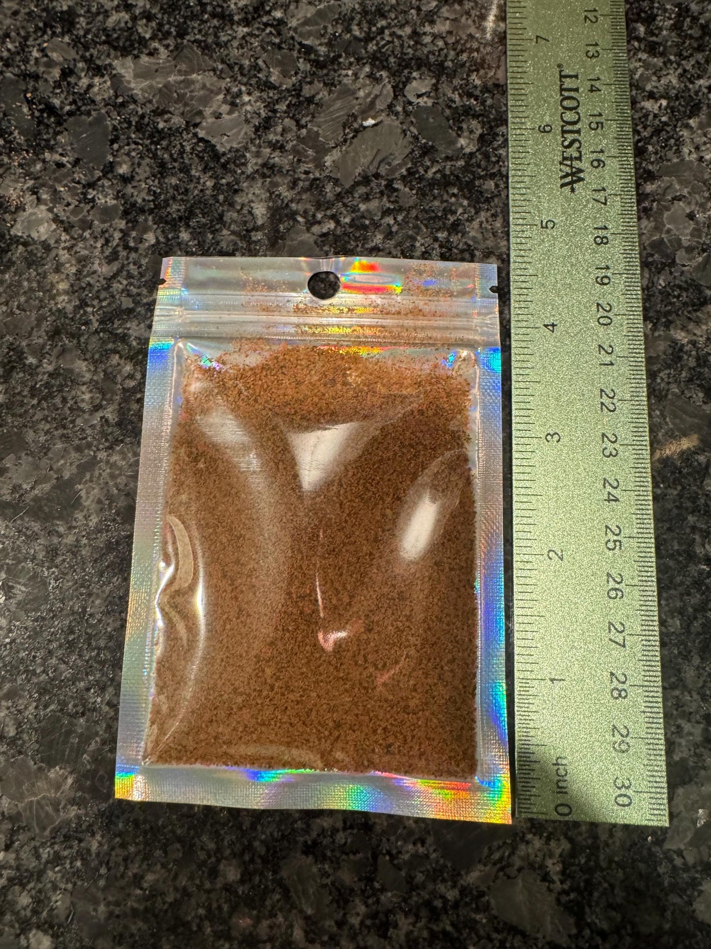 May include: A small, clear, iridescent, resealable bag with a brown powder inside for baby fish, fry food