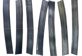 Five black aquarium weights, each with a slightly different curve and texture. The strips are arranged in a row, with the most curved strip on the left and the least curved strip on the right.