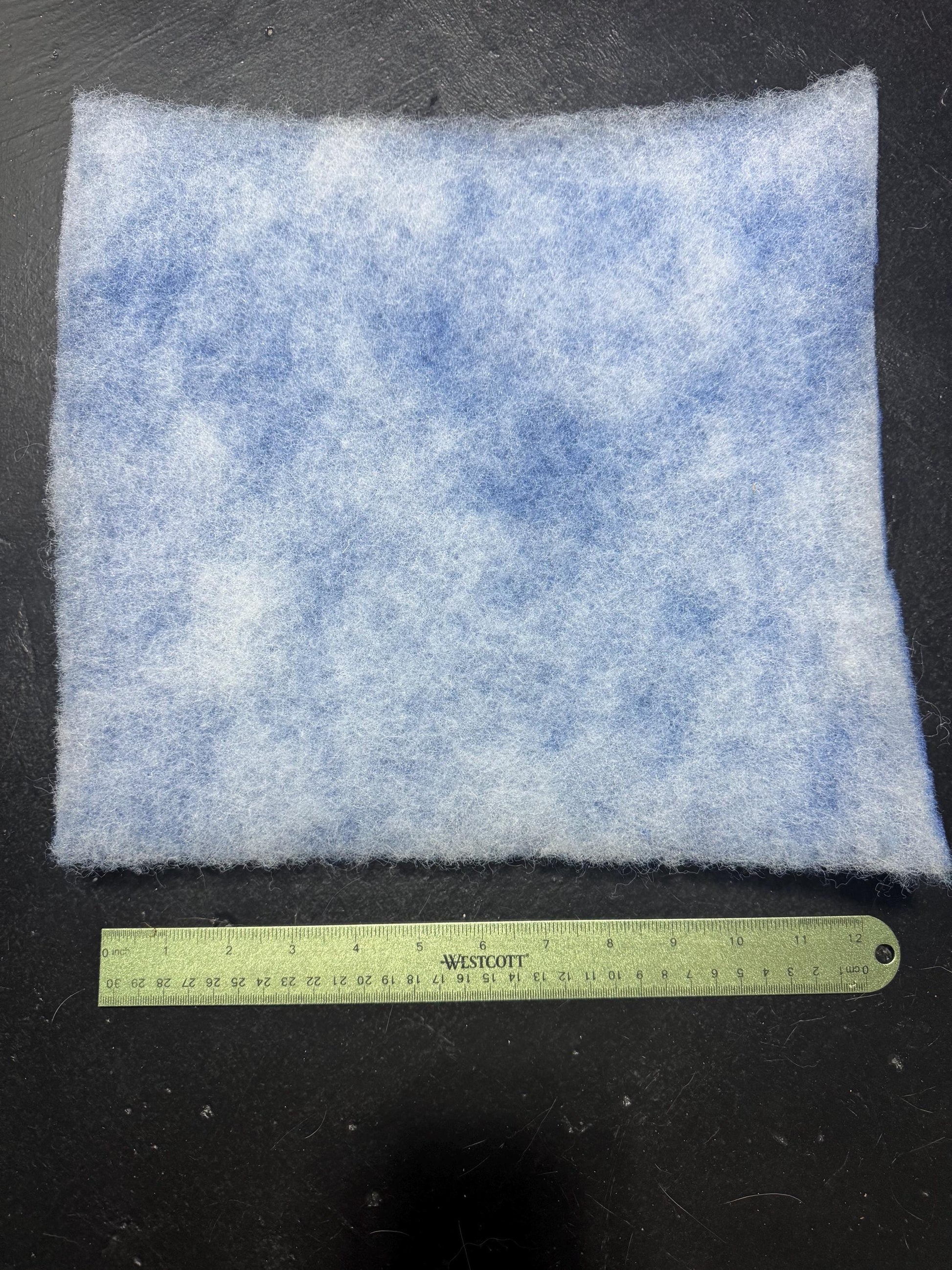 back side of 12x12 filter pad with ruler showing measurements