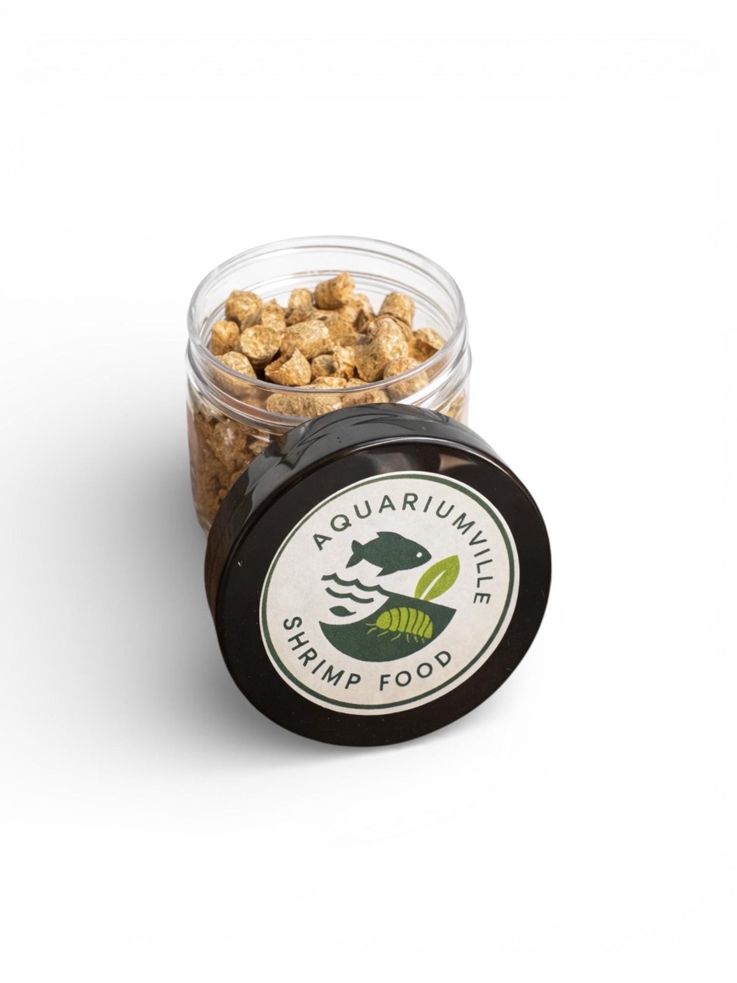 AquariumVille shrimp barley pellets in a clear jar with black lid and “AquariumVille Shrimp Food” label on a white background.